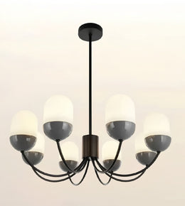 A modern 6-light chandelier with a matte black metal frame and semi-opaque white glass shades, shown against a plain off-white background.