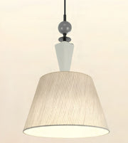 A modern pendant light fixture with a large tapered drum shade featuring vertical pleats, a white cone-shaped neck, a dark gray spherical accent, and a black hanging cord against a plain off-white background.