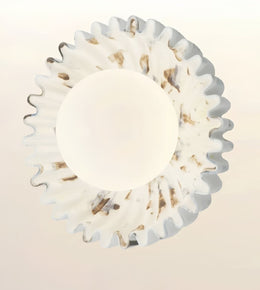 A circular white wall sconce with a scalloped, fluted outer rim and a smooth central dome, shown against a plain light background.