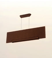 A modern rectangular pendant light fixture in a dark brown finish with a subtle chevron pattern, suspended by two thin cables against a plain off-white background.