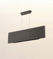 A modern rectangular pendant light fixture with a textured chevron pattern, suspended by thin cables from a matching ceiling mount against a plain off-white background.