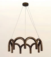 A modern multi-light linear chandelier with a bronze finish, featuring curved tubular arms suspended by thin cables from a round ceiling canopy, shown against a plain light background.