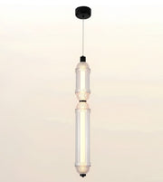 A modern two-light linear pendant ceiling fixture with clear textured glass shades and black metal accents, suspended by a thin cord from a black ceiling canopy.