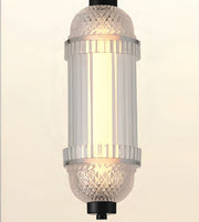 A cylindrical pendant light fixture with a warm white illuminated glass shade, featuring textured clear glass caps and silver-toned metal bands, shown against a plain light background.