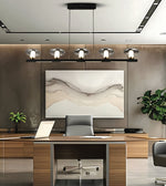 A modern office interior with a large rectangular abstract wall art piece hanging above a wooden desk. The artwork has soft beige, cream, and gray wavy lines on a white background.