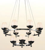 A modern multi-light chandelier with a circular chrome ring, nine textured frosted glass shades, and glossy black bowl-shaped metal accents, suspended by thin cables against a light beige background.