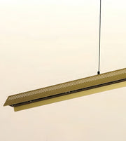 A modern linear pendant light fixture in a brushed brass or gold finish, suspended by a thin black cord against a plain off-white background.