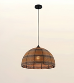 A dome-shaped pendant light with a woven natural rattan shade and black metal frame, suspended by a black cord from a black ceiling canopy against a plain off-white background.
