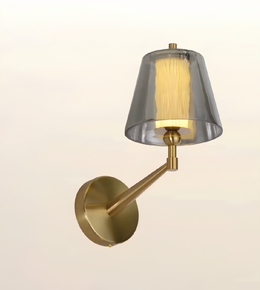 Luxury brushed brass wall light with smoked glass outer shade and textured inner diffuser, modern decorative wall sconce for bedrooms, living rooms, hotels, and contemporary interiors.