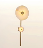 Luxury brushed brass wall light with dual natural alabaster stone discs, modern decorative wall sconce for bedrooms, living rooms, hallways, hotels, and contemporary interiors.