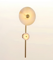Luxury brushed brass wall light with dual natural alabaster stone discs, modern decorative wall sconce for bedrooms, living rooms, hallways, hotels, and contemporary interiors.