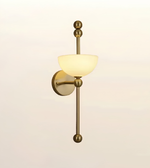 Luxury brushed brass wall light with a single opal glass shade, modern decorative wall sconce for bedrooms, hallways, living rooms, hotels, and contemporary interiors.