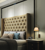 Luxury brushed brass wall light with elegant fabric lampshade, modern bedside wall sconce for bedroom, living room, hotel suite, and contemporary interiors.