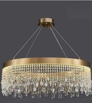 Gold chandelier with crystal accents on a dark background