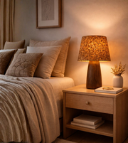 Modern cork shade table lamp with wood-grain base creating warm ambient lighting in a luxury bedroom.