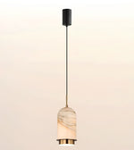 A modern pendant light with a black cylindrical ceiling canopy, a slim black cord, and a warm white marble shade with gold-toned metal accents.