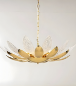 Gold chandelier with leaf-like design on a white background