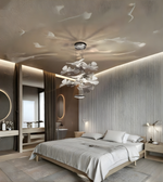 Modern bedroom with a ceiling light fixture, bed, and decorative elements.