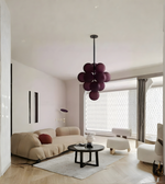 Modern living room with a stylish purple pendant light fixture.