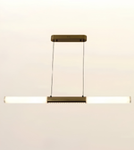 A modern linear pendant light fixture with a horizontal bar, featuring a brushed brass or bronze metal frame and a glowing white frosted glass tube. It hangs from a matching rectangular ceiling canopy with two thin suspension wires, set against a plain off-white background.