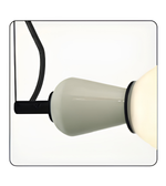 Close-up of a light bulb with a white base and black cord on a white background