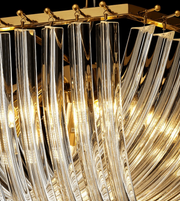 Close-up of a chandelier with crystal-like design and gold accents.