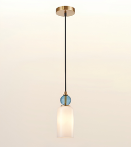 A modern single-light pendant fixture with a round gold ceiling canopy, a black cord, a small blue faceted glass accent, and a frosted white glass shade, shown against a plain off-white background.