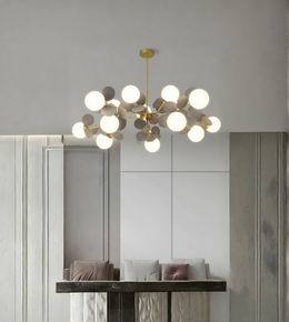 Modern chandelier hanging in a room with neutral decor