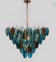 Decorative chandelier with blue and gold leaf-like design on a gray background