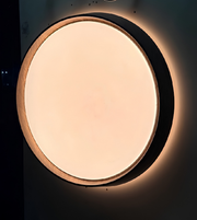 Round ceiling light fixture on a dark background