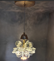 Crystal chandelier hanging against a textured wall