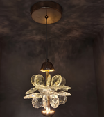 Decorative chandelier hanging from a ceiling light fixture against a dark background