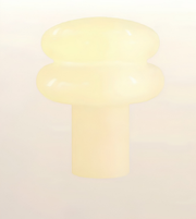 A pale cream-colored plastic or resin knob with a rounded, mushroom-like top and a cylindrical base, shown against a plain light background.