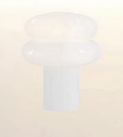 A frosted white plastic or silicone cap with a rounded, mushroom-like top and a cylindrical base, shown against a soft, light beige gradient background.