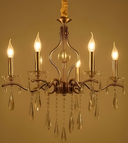 Gold chandelier with crystal accents on a gold background