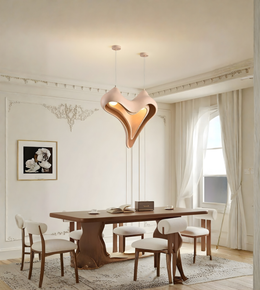 Modern dining room with a heart-shaped pendant light, wooden table, and white chairs.