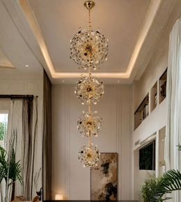 Modern chandelier hanging in a stylish living room with plants and artwork.