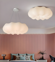 Two cloud-shaped ceiling lights in a bedroom with a pink paneled wall.