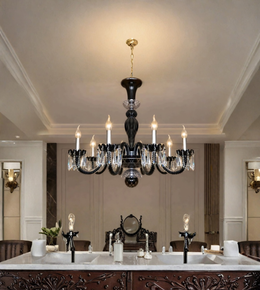  Black crystal chandelier with illuminated candle-style bulbs and hanging crystal accents above a formal dining table in an elegant interior.