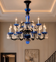 Close-up of a luxury chandelier featuring blue decorative accents, a black frame, and clear crystal-style hanging ornaments.