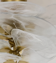 Close-up of a luxury glass chandelier with organic sculptural detailing.