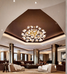 A large modern chandelier with white flower-like glass shades and gold-toned metal arms hangs in a high-ceilinged contemporary living room with brown walls and beige sofas.