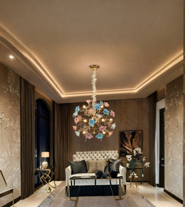Pastel floral crystal chandelier suspended above a sofa in an elegant living room with warm lighting and contemporary luxury décor.