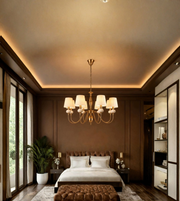 Gold eight-light chandelier with ivory pleated shades suspended in an elegant bedroom with rich brown wall panelling.
Copy alt text