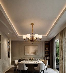 An elegant dining room interior featuring a multi-light chandelier with white globe shades and a gold-toned frame hanging over a long dining table. The room has a high coffered ceiling with warm LED lighting, gray walls, built-in shelving, and large curtains.
