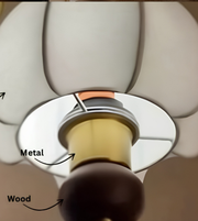 Close-up showing the brass-tone metal fitting and dark wood decorative detail beneath a white glass chandelier shade.