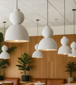 Aura Duo pendant light in white and grey finishes with double-dome design, modern sculptural lighting for bedrooms, dining rooms, and cafes.