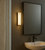 Bathroom setting with a mirror, light fixture.