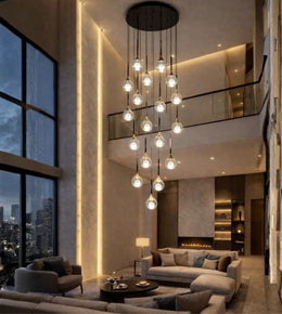 Modern glass drop cascade chandelier in a luxury double height living room with warm lighting