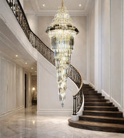 Royal glass spiral cascade staircase chandelier with warm lighting in a grand luxury interior